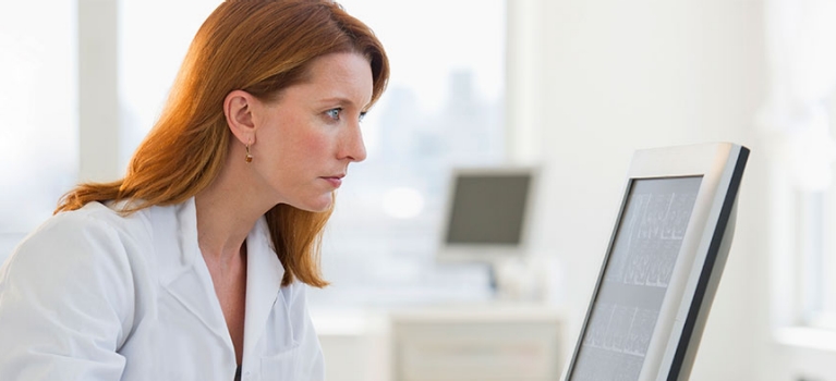 Doctor sitting at computer